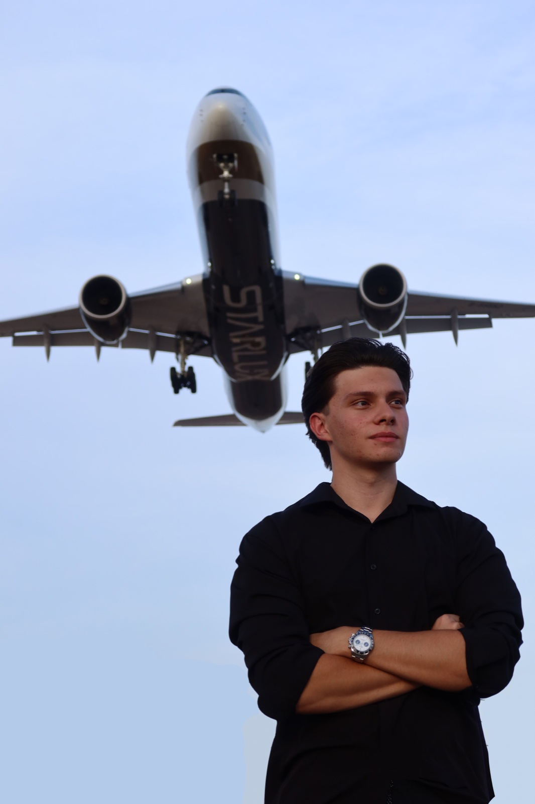 Andrew Cimpean with an aircraft on approach in the background